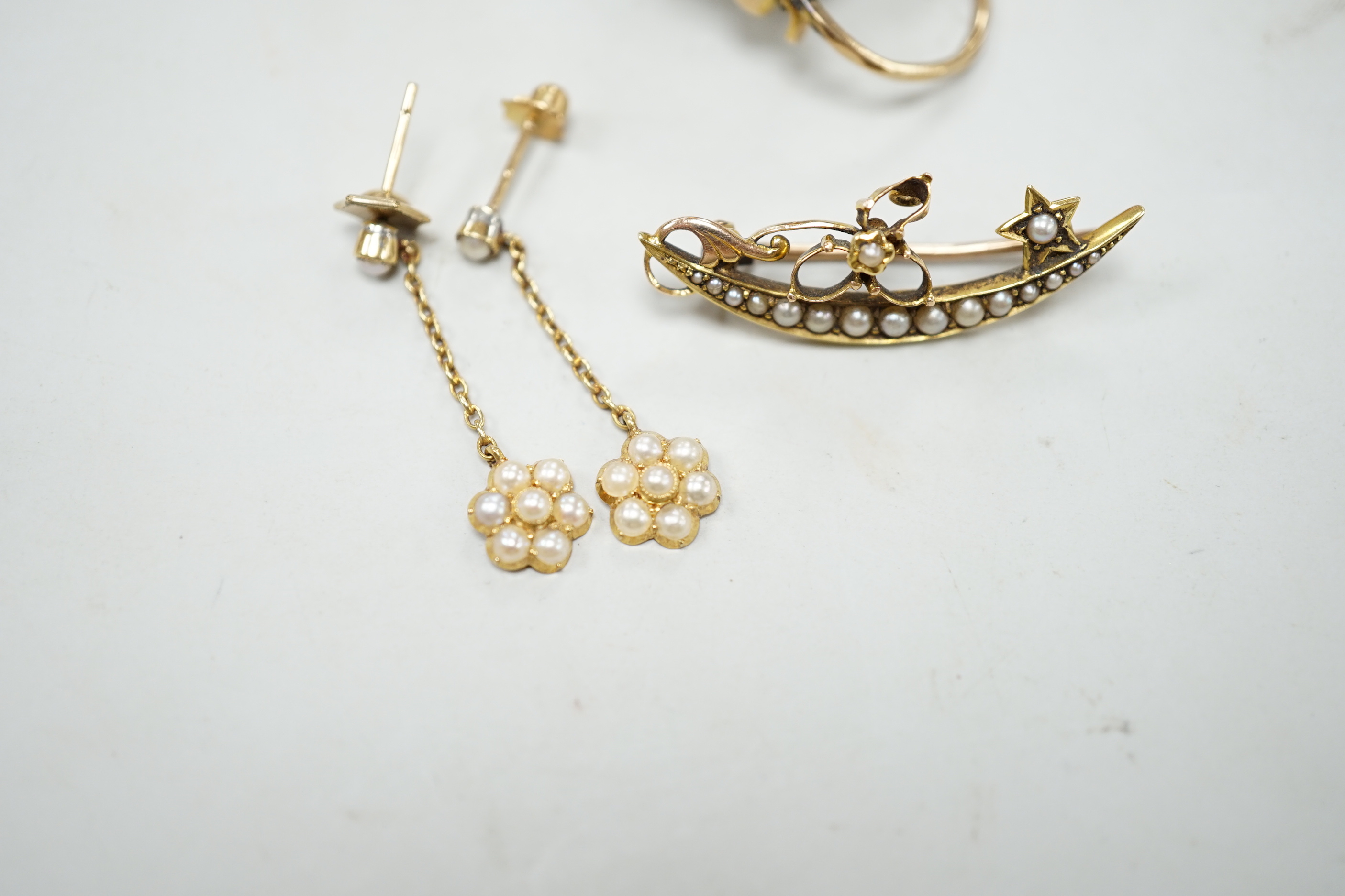 A Victorian yellow metal, garnet and seed pearl set heart shaped locket pendant, 36mm, a pair of Edwardian 15ct and seed pearl cluster set drop earrings and a yellow metal set seed pearl brooch.